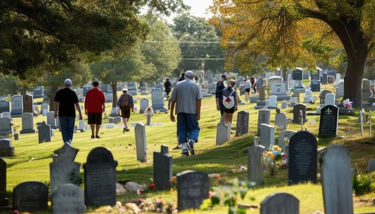 People Walking In Cemetery Looking At Graves